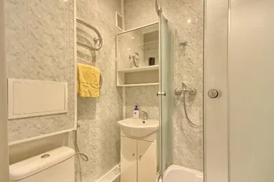 a bathroom with a shower and a toilet and a sink at Apartamentai Vilniaus alėjoje in Druskininkai