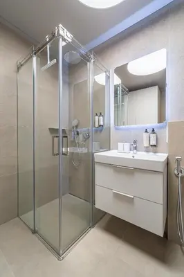a bathroom with a glass shower and a sink at cohost I New Apt w-Balcony I Air Condition I Free Parking & Netflix I By Botanical Park in Kaunas