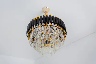 a chandelier hanging from a ceiling at Kestutis Luxury Apartment in Šiauliai