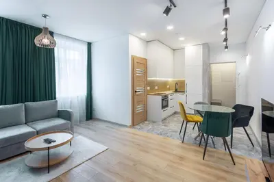 a living room with a couch and a table at Kestutis Luxury Apartment in Šiauliai