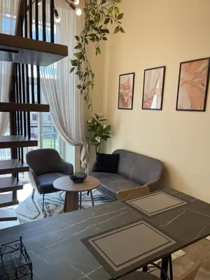 a living room with a couch and a table at Mini loft in Kaunas