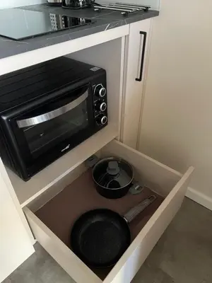 a microwave oven in a drawer in a kitchen at Mini loft in Kaunas