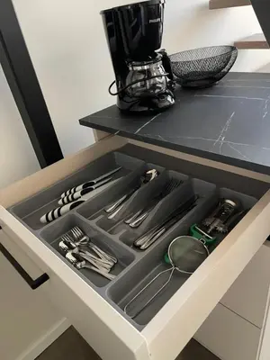 a drawer in a kitchen with utensils in it at Mini loft in Kaunas
