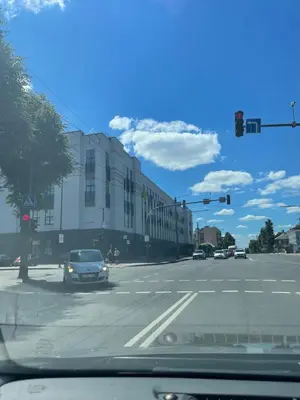 a car driving down a city street with a traffic light at Mini loft in Kaunas