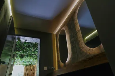 a room with a window and a ceiling with a mirror at Sodyba Mėnulio Slėnis in Padubysys