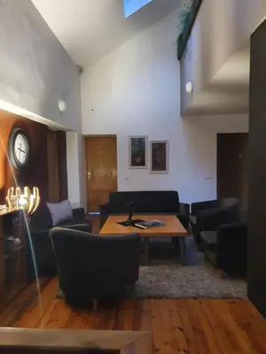a living room with a table and chairs at Sveciu Namai Giles in Alytus