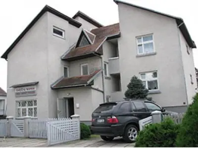 a black car parked in front of a house at Sveciu Namai Giles in Alytus