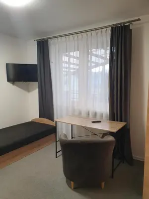 a room with a desk and a chair and a bed at Sveciu Namai Giles in Alytus