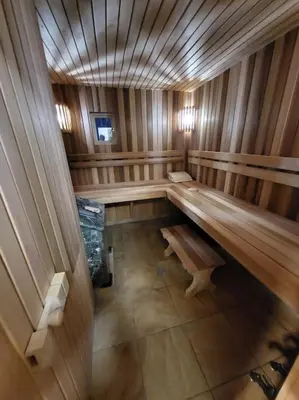 a inside of a sauna with a bench in it at Ramus poilsis miške su kedro pirtimi ir kubilu in Marcinkonys