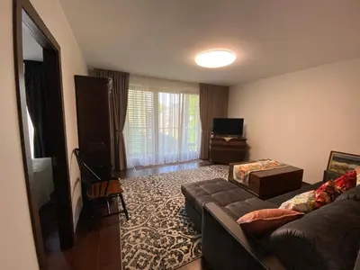 a living room with a couch and a television at Apartamentai prie Kalnų parko in Vilnius