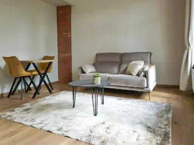 a living room with a couch and a table at Rossak apartment 1 in Panevėžys