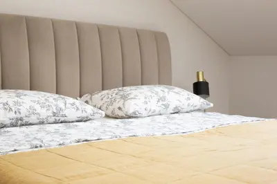 a bed with two pillows on top of it at Rossak apartment 2 in Panevėžys