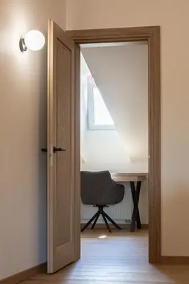 an open door leading to a desk and a chair at Rossak apartment 2 in Panevėžys