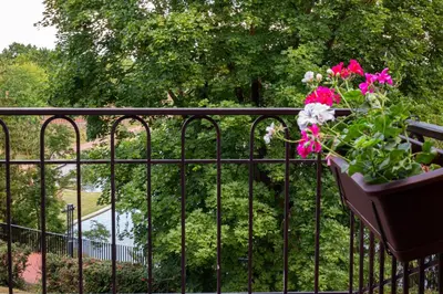 a potted plant on a fence with pink flowers at Rossak apartment 2 in Panevėžys