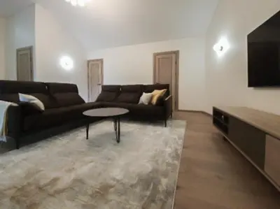 a living room with a couch and a table at Rossak apartment 2 in Panevėžys