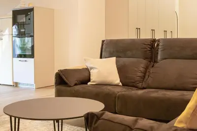 a living room with a brown couch and a table at Rossak apartment 2 in Panevėžys