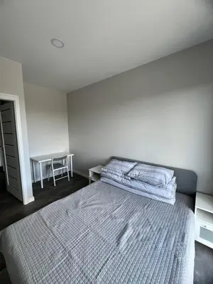 a bedroom with a bed and a desk with a chair at Bright and cozy place to stay in Vilnius