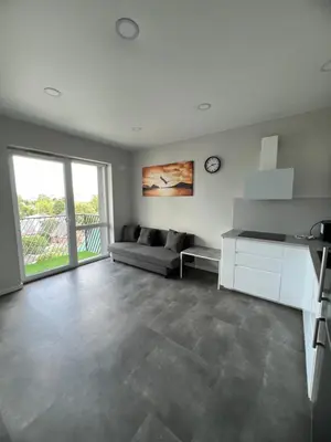 a living room with a couch and a table at Bright and cozy place to stay in Vilnius
