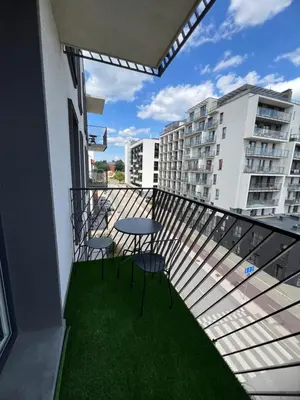 a balcony with a table and chairs on it at Bright and cozy place to stay in Vilnius
