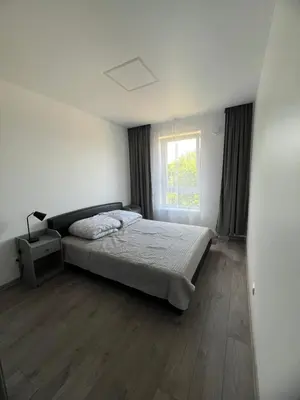 a bedroom with a bed and a window at Cozy place near old town in Vilnius