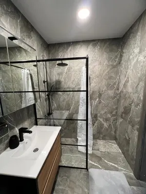 a bathroom with a shower and a white sink at Cozy place near old town in Vilnius