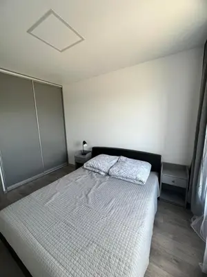 a bedroom with a white bed in a room at Cozy place near old town in Vilnius