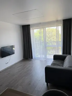 a living room with a couch and a television at Cozy place near old town in Vilnius