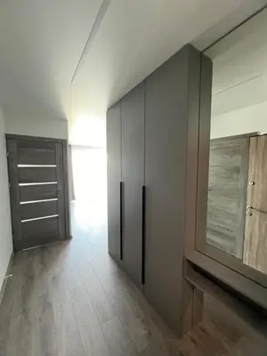 a living room with a cabinet and a tv at Cozy place near old town in Vilnius