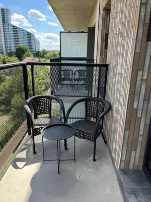 two chairs and a table on a balcony at Cozy place near old town in Vilnius