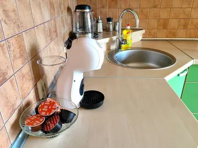 a kitchen counter with a mixer and bowls of strawberries at Lyra cozy large apartment in Šiauliai