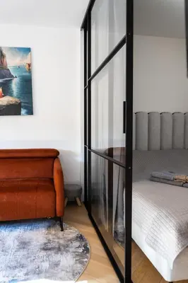 a room with a bed and a glass case at SongInn Lake Apartment in Zarasai