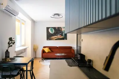 a living room with a couch and a table at SongInn Lake Apartment in Zarasai