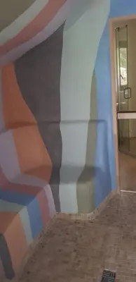 a wall with a painting on the side of a room at Jaukūs namai Kulautuvoje in Kulautuva