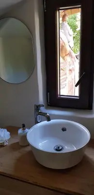 a bathroom with a white sink and a mirror at Jaukūs namai Kulautuvoje in Kulautuva