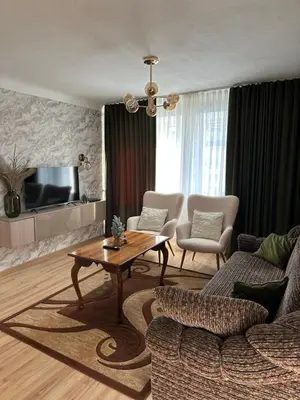 a living room with a couch and a table at Suncity 2 apartamentai in Šiauliai