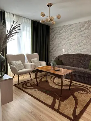 a living room with a table and a couch at Suncity 2 apartamentai in Šiauliai