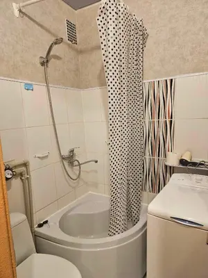 a bathroom with a shower and a tub and a toilet at Suncity 2 apartamentai in Šiauliai