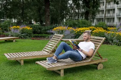 a man sitting on a chair reading a book at Medical SPA 