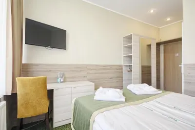a bedroom with a bed and a desk and a television at Medical SPA 