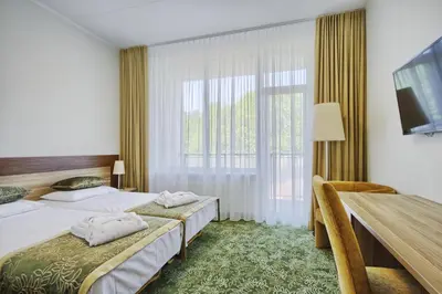 a hotel room with two beds and a large window at Medical SPA 