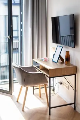 a desk with a laptop and a chair in a room at Renaissance Apartments by Reside Baltic in Vilnius