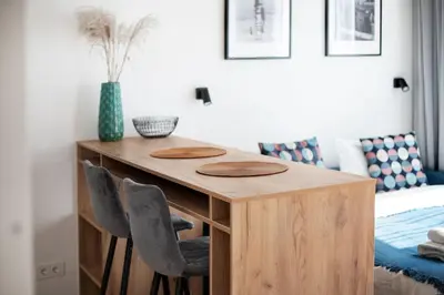 a bedroom with a table and chairs next to a bed at Renaissance Apartments by Reside Baltic in Vilnius