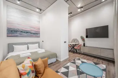 a bedroom with a bed and a flat screen tv at Renaissance Apartments by Reside Baltic in Vilnius