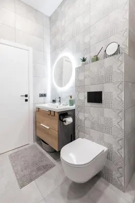 a bathroom with a toilet and a sink and a mirror at Renaissance Apartments by Reside Baltic in Vilnius