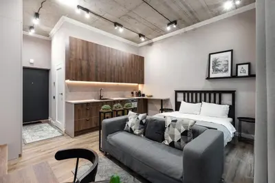 a living room with a bed and a couch at Renaissance Apartments by Reside Baltic in Vilnius