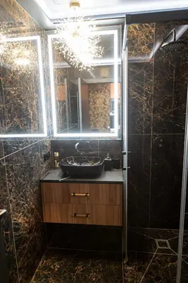 a bathroom with a sink and a mirror at AMJ Royal Apartments - 115 - Black Rubby in Kaunas