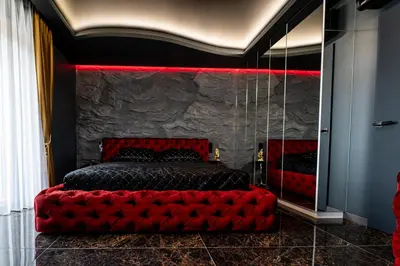 a bedroom with a red bed and a mirror at AMJ Royal Apartments - 115 - Black Rubby in Kaunas