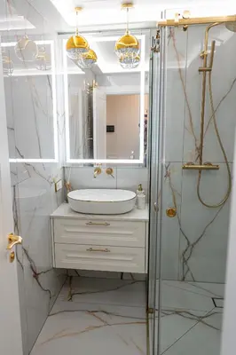 a bathroom with a sink and a shower with a mirror at AMJ Royal Apartments - 120 - Royal Classic in Kaunas