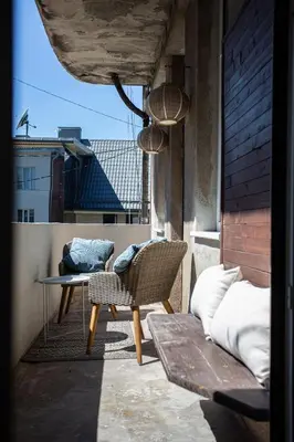 a balcony with a chair and a table on a building at Greenhill Trio in Kaunas