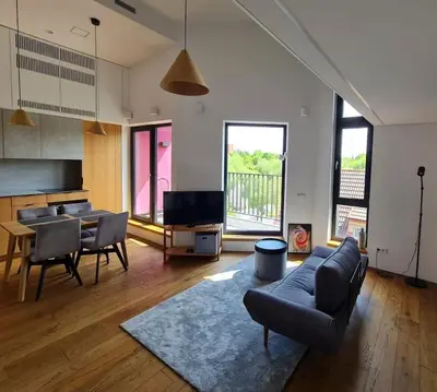 a living room with a couch and chairs and a table at Sunny Cosy Home in Kaunas
